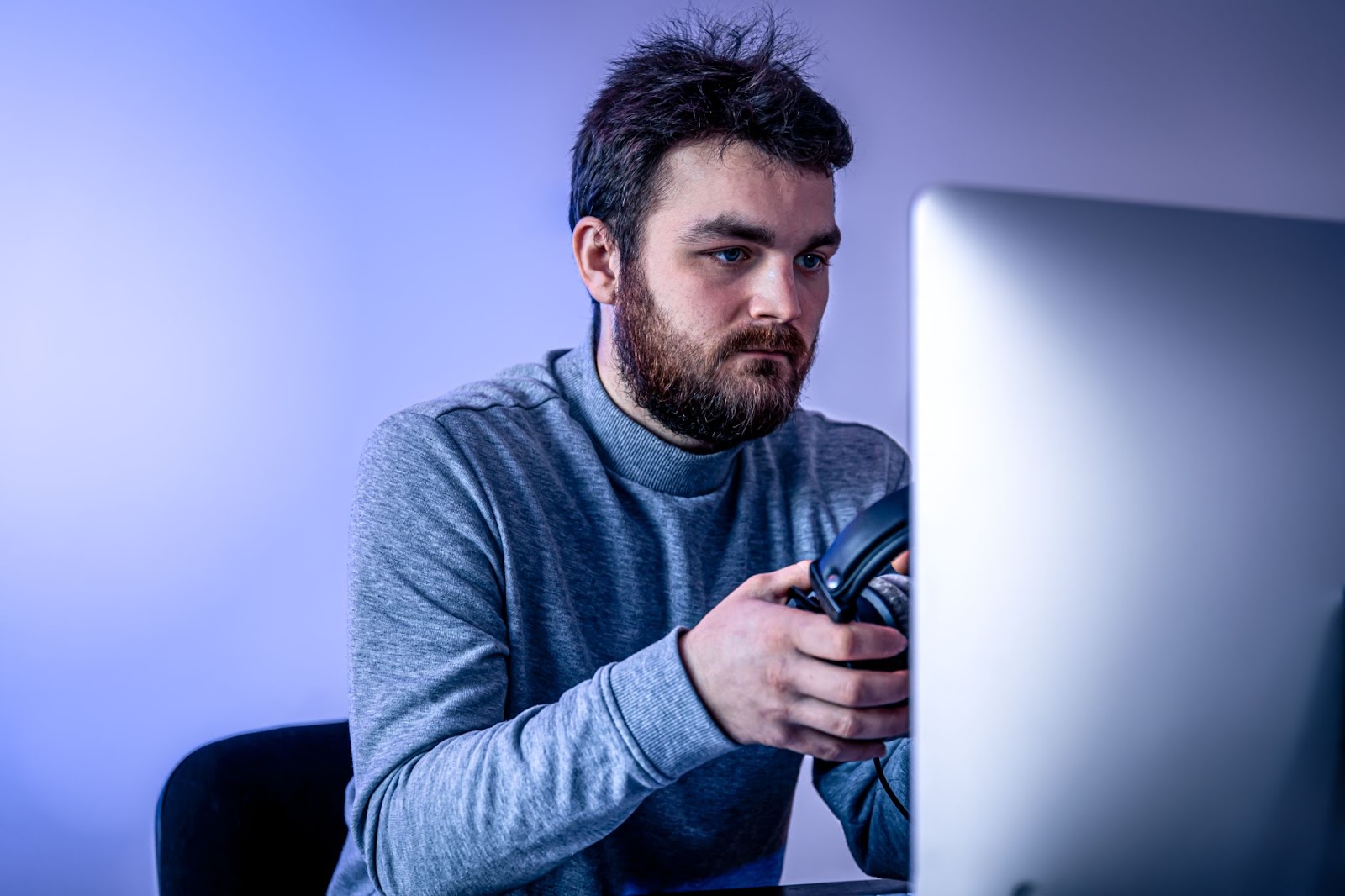 The man stares intently at the computer