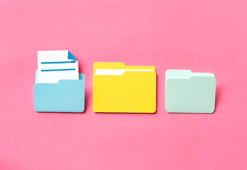 file folders against a pink background